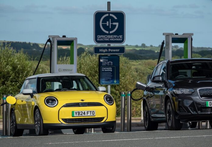 Cars recharge at a charging station for electric vehicles at Cornwall service station near Saint Austell in Cornwall, England