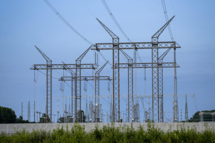 Transmission lines feed into a substation near a data center construction site on July 24 in Lewis Center, Ohio. Credit: Eli Hiller/The Washington Post via Getty Images