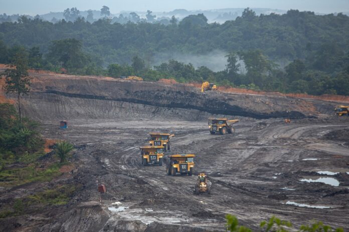 Coal mining trucks at an opencast coal mine in Kalimantan, Indonesia